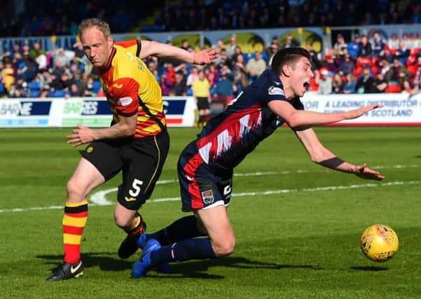 Ross County's Ross Stewart goes down under a challenge from Partick Thistle's Steven Anderson. Pic: SNS/Paul Devlin