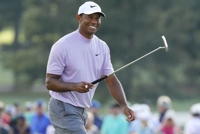 Tiger Woods smiles as he walks on the 18th hole during the third round at Augusta National. Picture: Getty Images