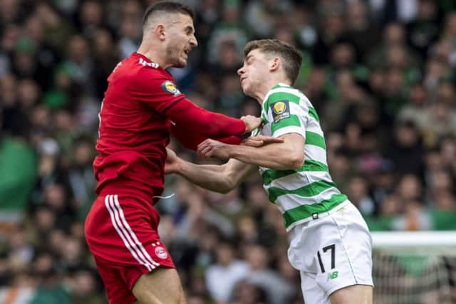 Celtic's Ryan Christie suffers an injury (right) after a clash with Aberdeen's Dominic Ball. Picture: SNS