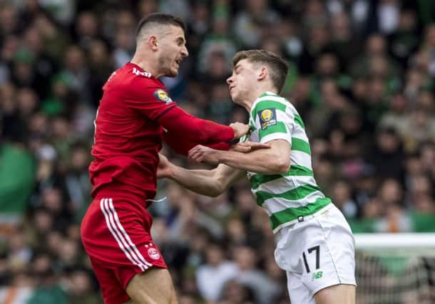 Celtic's Ryan Christie suffers an injury (right) after a clash with Aberdeen's Dominic Ball. Picture: SNS