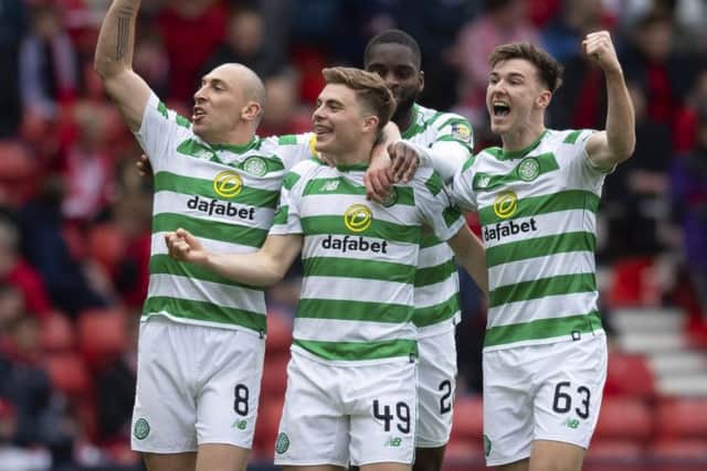 James Forrest, centre, celebrates with his team-mates after giving Celtic the lead. Picture: SNS