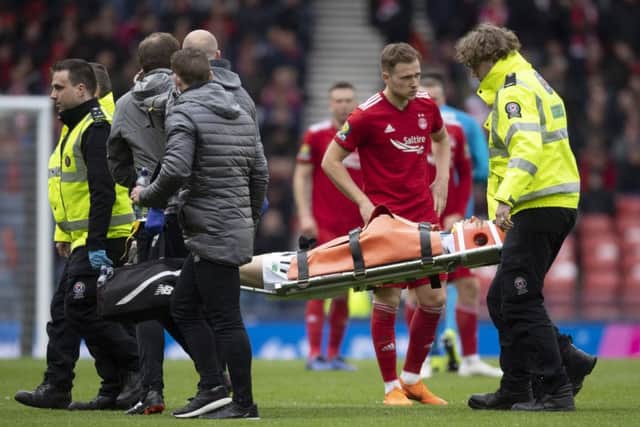 Celtic's Ryan Christie is stretchered off after suffering an injury. Picture: SNS