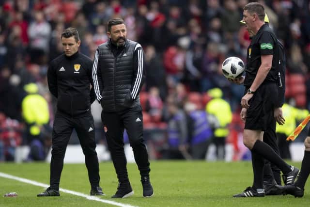 Aberdeen manager Derek McInnes exchanges words with referee Craig Thomson at full-time. Picture: SNS