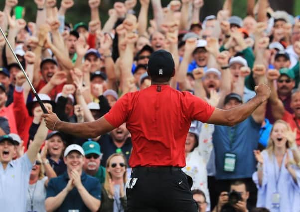 Tiger Woods of the United States celebrates after sinking his putt on the 18th green to win during the final round of the Masters at Augusta National Golf Club. (Photo by David Cannon/Getty Images)