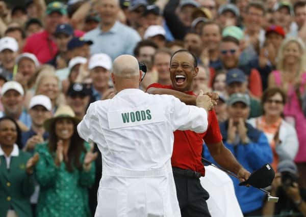 Tiger Woods celebrates  with his caddie, Joe LaCava, at Augusta on Sunday.