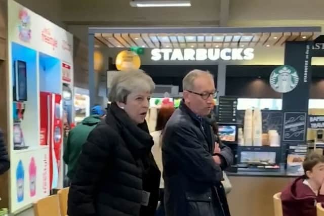 Prime Minister Theresa May stuns motorists as she stops off at a service station on the M54. SWNS