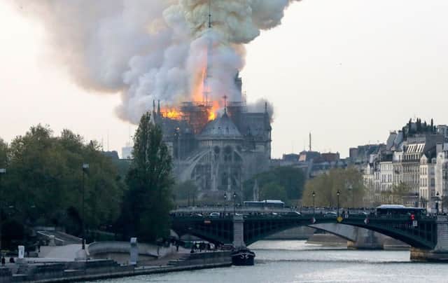 Smokes ascends as flames rise during a fire at the landmark Notre-Dame Cathedral in central Paris on April 15, 2019 afternoon, potentially involving renovation works being carried out at the site, the fire service said. (Photo by FRANCOIS GUILLOT / AFP)FRANCOIS GUILLOT/AFP/Getty Images