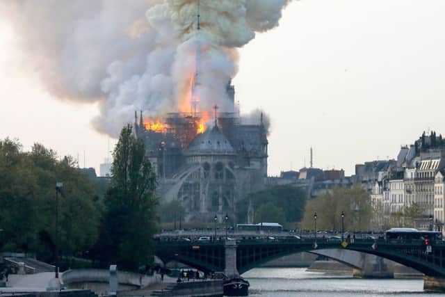 Smokes ascends as flames rise during a fire at the landmark Notre-Dame Cathedral in central Paris. Picture: Getty Images