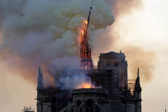 The steeple of the landmark Notre-Dame Cathedral collapses as the cathedral is engulfed in flames. Picture: Getty Images