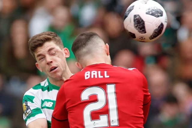 Ryan Christie comes off worse in an aerial challenge with Aberdeen's Dominic Ball. Picture: Steve Welsh