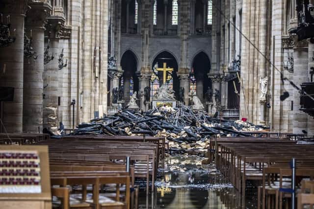 Firefighters declared success Tuesday in a more than 12-hour battle to extinguish an inferno engulfing Paris' iconic Notre Dame cathedral that claimed its spire and roof, but spared its bell towers and the purported Crown of Christ. (Christophe Petit Tesson, Pool via AP)