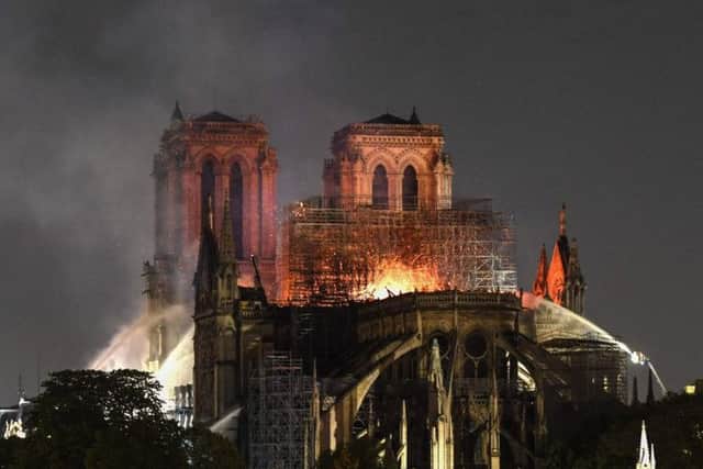 Flames and smoke are seen billowing from the roof at Notre-Dame Cathedral in Paris. Picture: Eric Feferburg/AFP/Getty Images