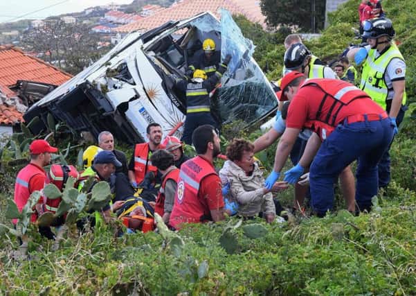 Firemen help victims of a tourist bus that crashed on the Portuguese island of Madeira. Picture: Rui Silva
