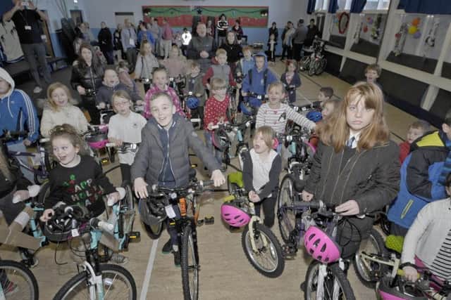 Bradley Welsh (at the very back) and his Helping Hands organisation hand out new bikes to the kids at Canal View Primary in 2017.