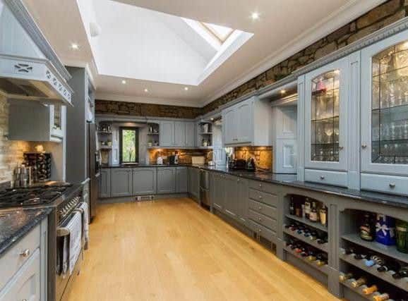The kitchen is bespoke with hand painted finishes and granite surfaces. There are fully integrated appliances and there is ample space for dining.