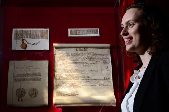 Abby Richards inspects the Edward I's English exchequer pipe roll from 1305, which reveals details of Sir William Wallace's execution. Picture: Mike Day/Saltire News