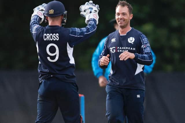 Con de Lange (right) celebrates with Matthew Cross after taking a wicket during his 5-60 haul against Zimbabwe in June 2017