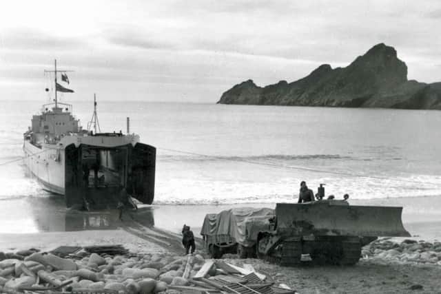 A landing craft and bulldozer pictured on the beach at Hirta, St Kilda, where more than 4,000 tonnes of equipment arrived for the tough construction job. PIC: NTS/Contributed.