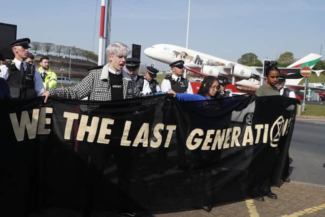 Police surround environmental protestors near Heathrow Airport in London, Friday, April 19, 2019.   (AP Photo/Frank Augstein)