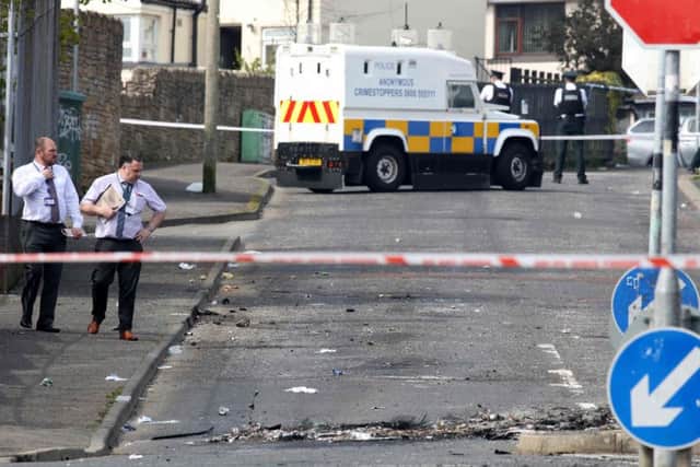 Police detectives inspect the scene where a journalist was fatally shot amid rioting overnight in the Creggan area of Derry (Londonderry) in Northern Ireland on April 19, 2019. Picture: Getty Images