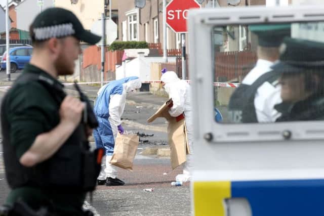 Police forensic experts inspect the scene where a journalist was fatally shot amid rioting overnight in the Creggan area of Derry (Londonderry) in Northern Ireland on April 19, 2019. (Photo by Paul Faith / Getty Images