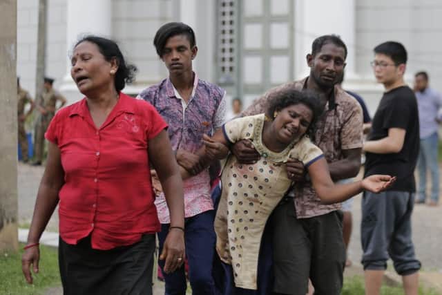 Relatives of a blast victim grieve outside a morgue in Colombo. More than 200 were killed and hundreds more hospitalized with injuries from eight blasts that rocked churches and hotels in and just outside of Sri Lanka's capital on Easter Sunday. Picture: AP/Eranga Jayawardena