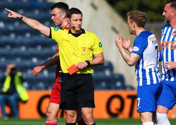 Referee Steven McLean brandishes his third red card of the afternoon, this time to Kilmarnock's Rory McKenzie. Picture: Gary Hutchison/SNS