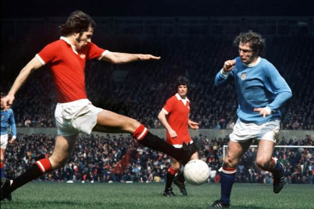 Jim Holton shows his trademark determination during the Manchester derby that relegated United at Old Trafford in 1974. Picture: Rex/Shutterstock.