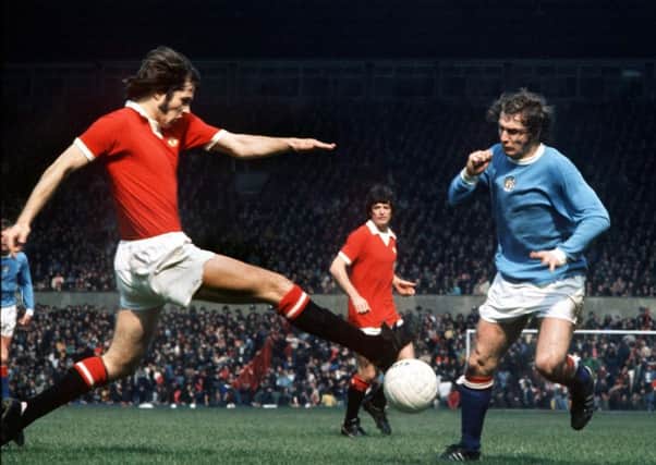 Jim Holton shows his trademark determination during the Manchester derby that relegated United at Old Trafford in  1974. Picture: Rex/Shutterstock.