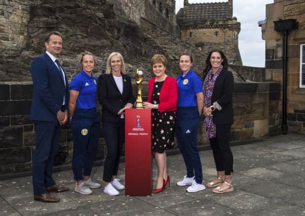 The Women's World Cup trophy at Edinburgh Castle, with (L-R): SFA chief executive Ian Maxwell, Joelle Murray, Shelley Kerr, First Minister Nicola Sturgeon, Lee Alexander and Julie Fleeting. Picture: SNS