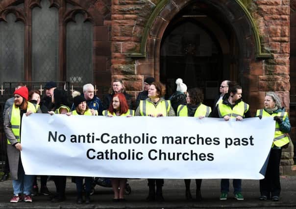 Silent protesters as Orange walk passes Glasgow church of attacked priest. Picture: John Devlin.