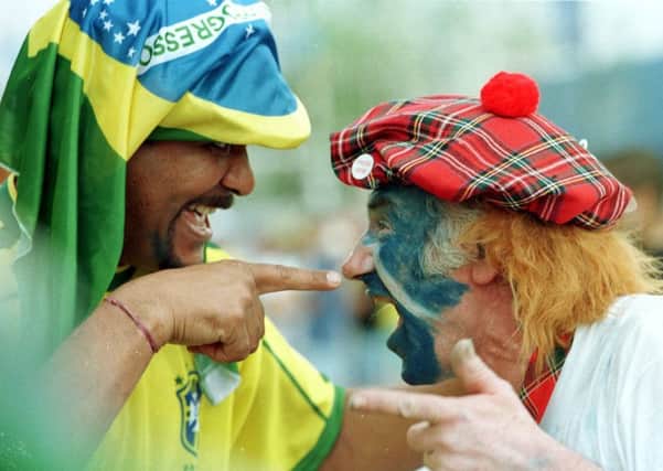 Brazilian fans meet the Tartan Army ahead of the opening game of the 1998 World Cup in Paris (Picture: Ian Rutherford)