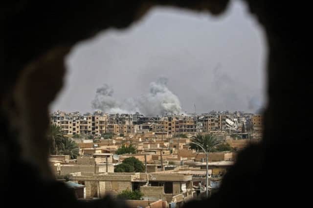 Smoke billows out following an air strike in the northern Syrian city of Raqa. Picture: Delil Souleiman/Getty