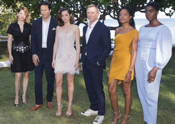Daniel Craig, posing with co-stars and crew on the new Bond film, once said hed rather slash my wrists than play the part again (Leo Hudson/AP)