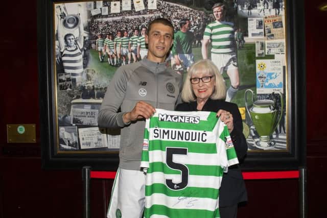Celtic's Jozo Simunovic hands his shirt over to Liz McNeill, wife of Billy, at the end of the match. Pic: SNS/Craig Williamson