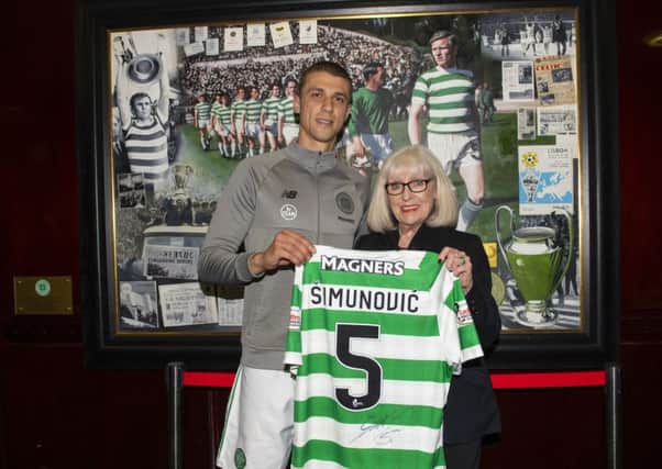 Celtic's Jozo Simunovic hands his shirt over to Liz McNeill, wife of Billy, at the end of the match. Pic: SNS/Craig Williamson