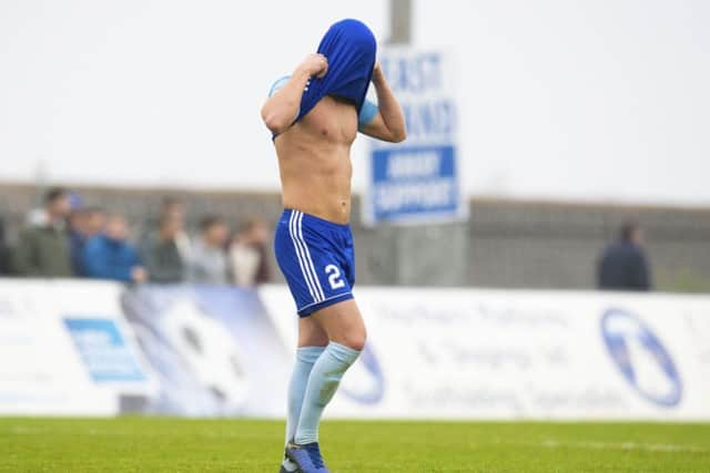 Peterhead's Jason Brown dejected after losing a late equaliser. Pic: SNS/Ross MacDonald