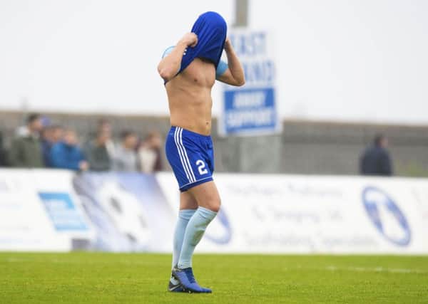Peterhead's Jason Brown dejected after losing a late equaliser. Pic: SNS/Ross MacDonald