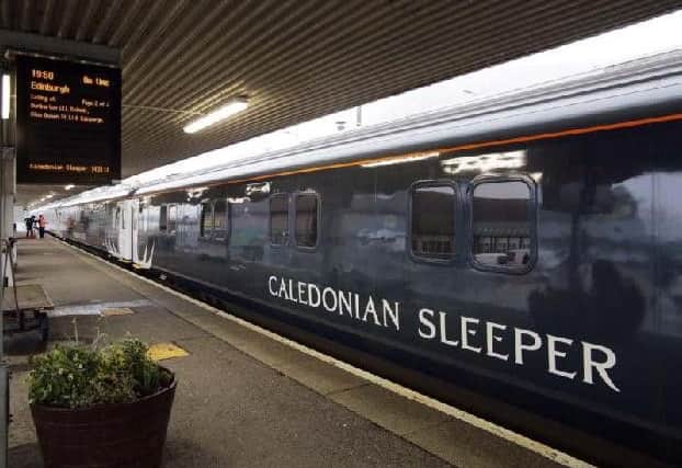The carriages have a midnight teal livery