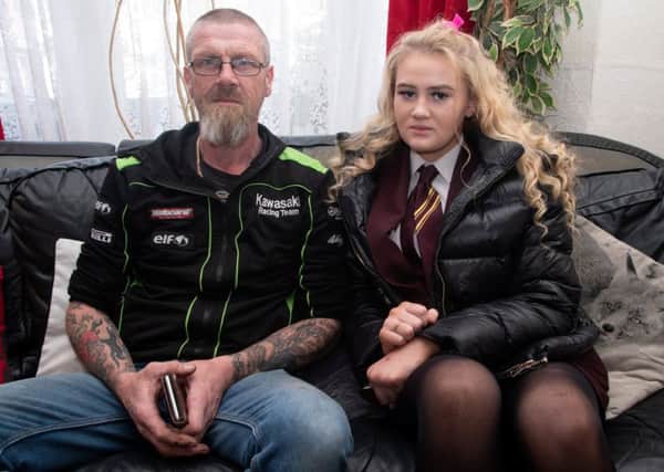 Ian Long with his daughter Kimberley (13) who has been sent home from school after getting her nose pierced. Picture: SWNS