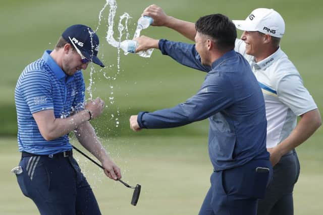 Winner Connor Syme is drenched in water by fellow Scots Ewen Ferguson and Calum Hill after securing his play-off victory. Picture: Getty Images