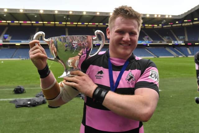 Pete McCallum poses with the cup following Ayrs victory. Picture: SNS/SRU.