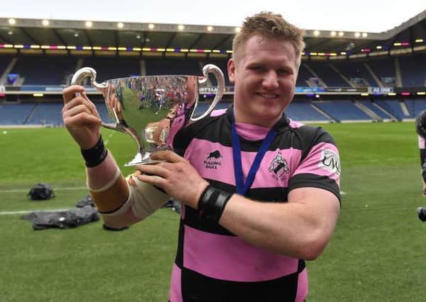 Pete McCallum poses with the cup following Ayrs victory. Picture: SNS/SRU.