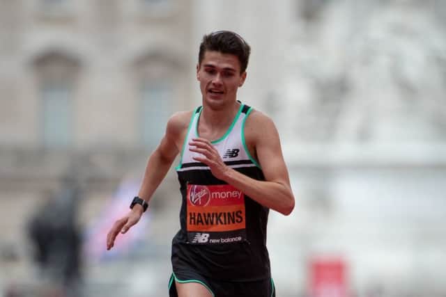 Callum Hawkins GBR crosses the finish line to place tenth and earn a personal best.
