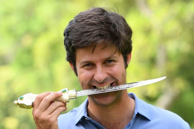 Spaniard Jorge Campillo jokingly bites the winner's dagger after claiming his maiden European Tour win in Morocco. Picture: Getty Images