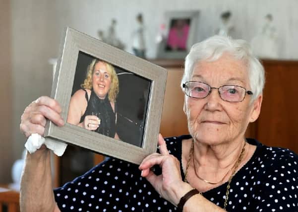 Jess McCartney ,82, holds a picture of grandaughter Laura Cartner, 38, who suffered a massive brain haemorrhage less than 24-hours after doctors told her she wasn't ill enough for a hospital bed. Picture: SWNS
