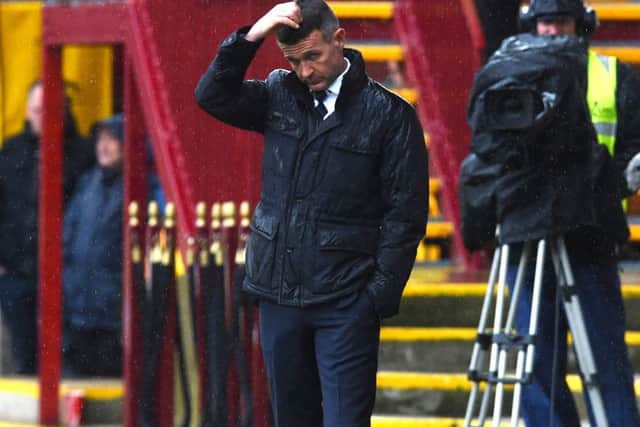 Jim McIntyre cuts a forlorn figure during Dundees agonising last-minute defeat by Motherwell on Saturday, but insists that he expects to remain in charge. Picture: SNS.