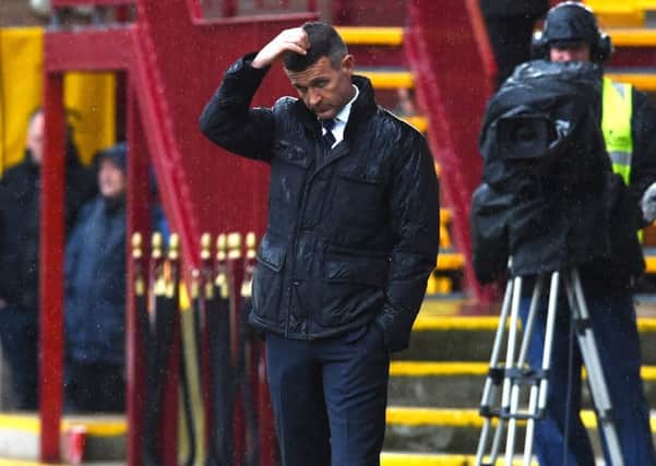 Jim McIntyre cuts a forlorn figure during Dundees agonising last-minute defeat by Motherwell on Saturday, but insists that he expects to remain in charge. Picture: SNS.