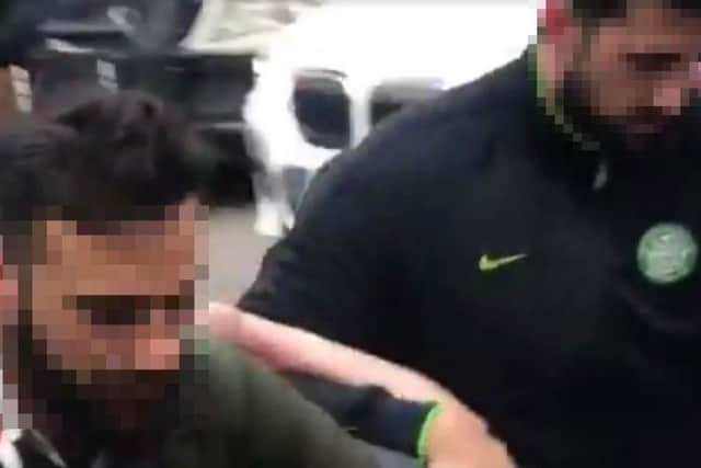 A football fan is arrested by a local police officer