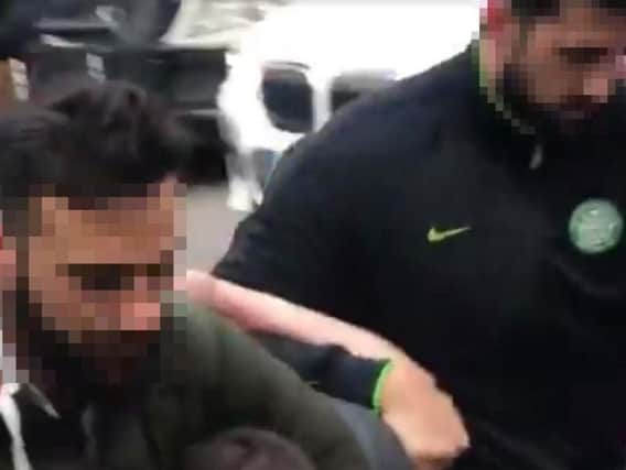 A football fan is arrested by a local police officer